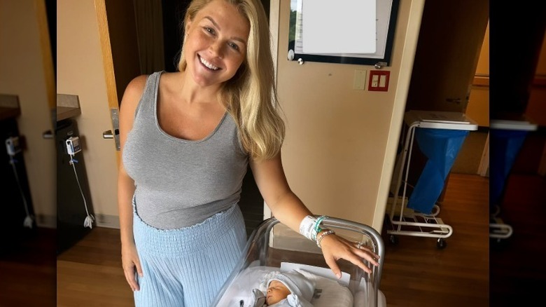 Karoline Leavitt posing with her newborn baby