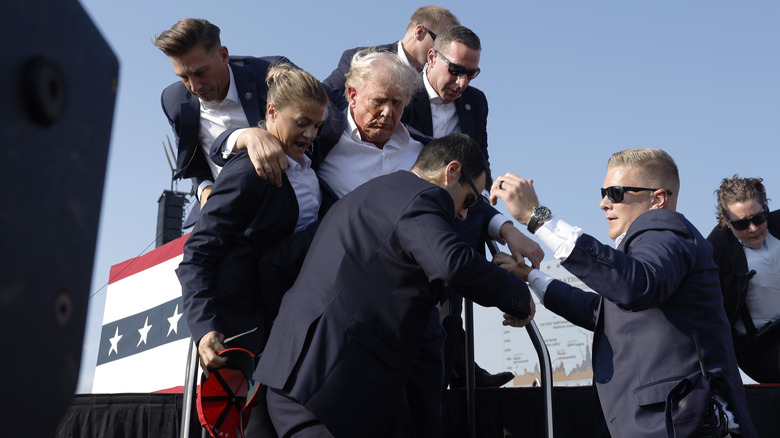 Donald Trump being ushered off stage