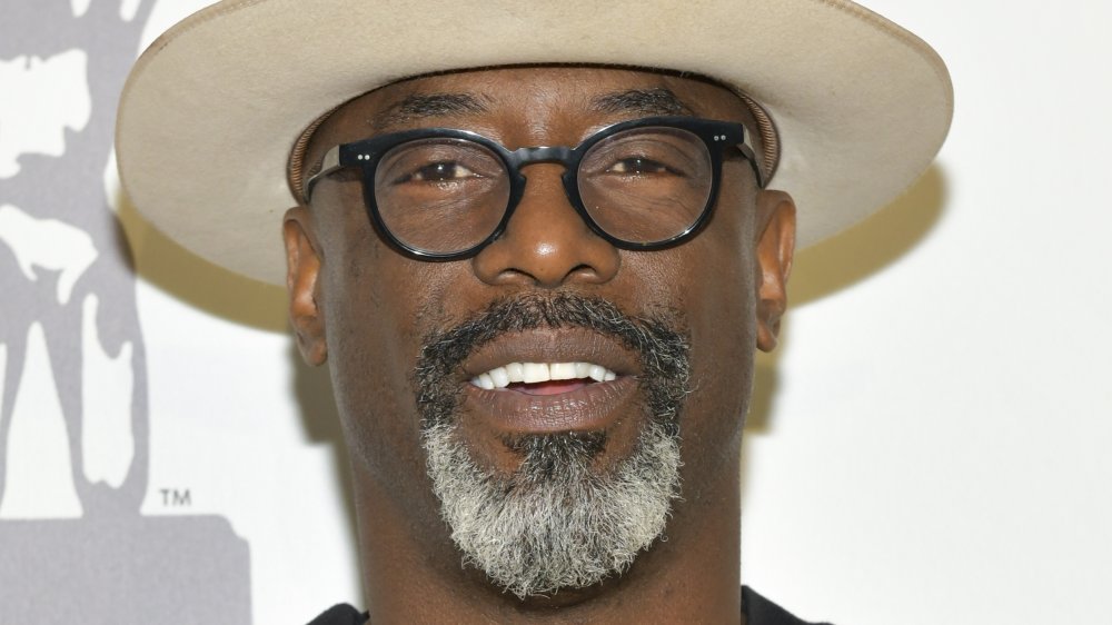 Isaiah Washington wearing a hat and glasses 