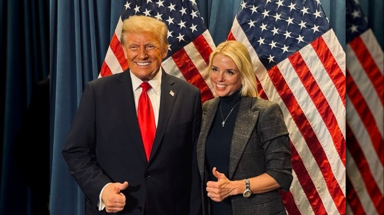 Donald Trump and Pam Bondi give the thumbs up in front of some American Flags