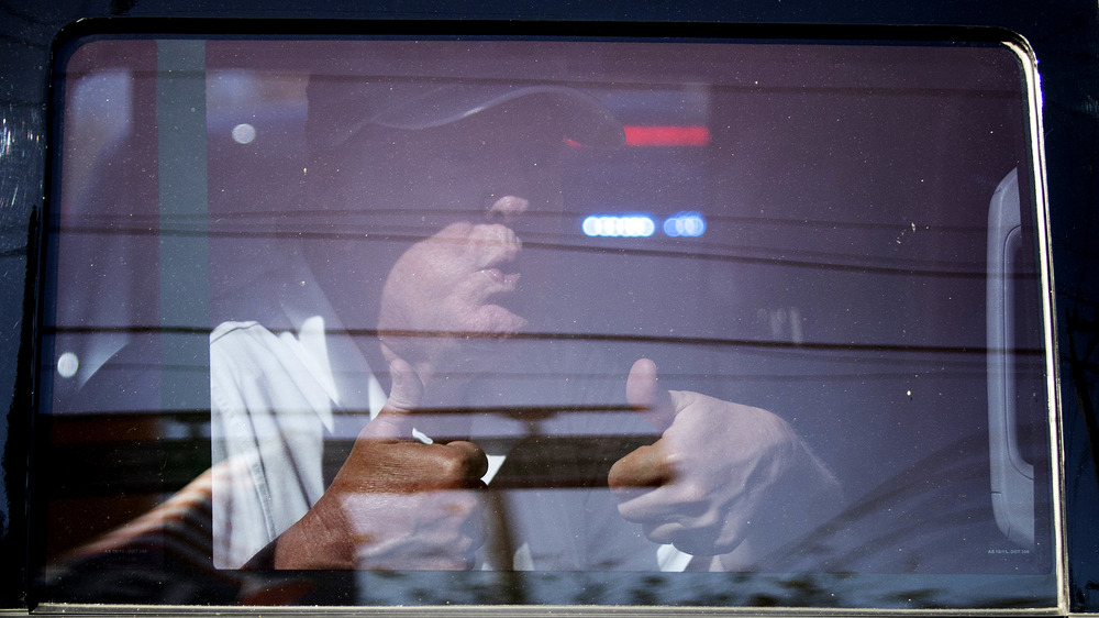 Donald Trump giving supporters two thumbs up from inside a car in Florida