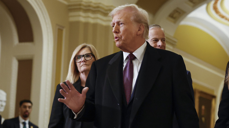 Donald Trump speaking with hand raised