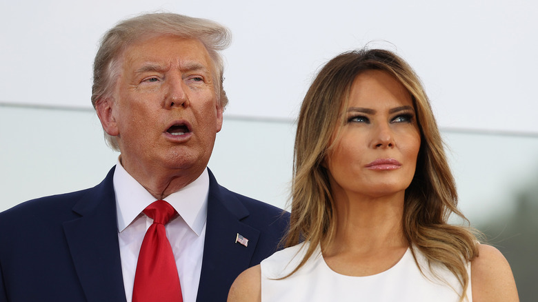 Donald Trump and Melania Trump looking away