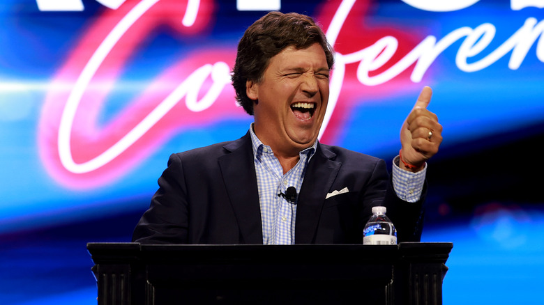 Tucker Carlson giving a thumbs up 