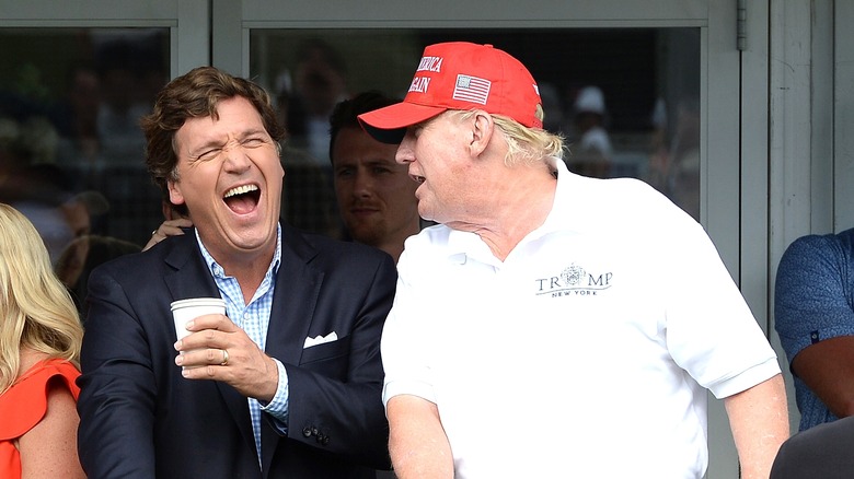 Tucker Carlson and Donald Trump laughing