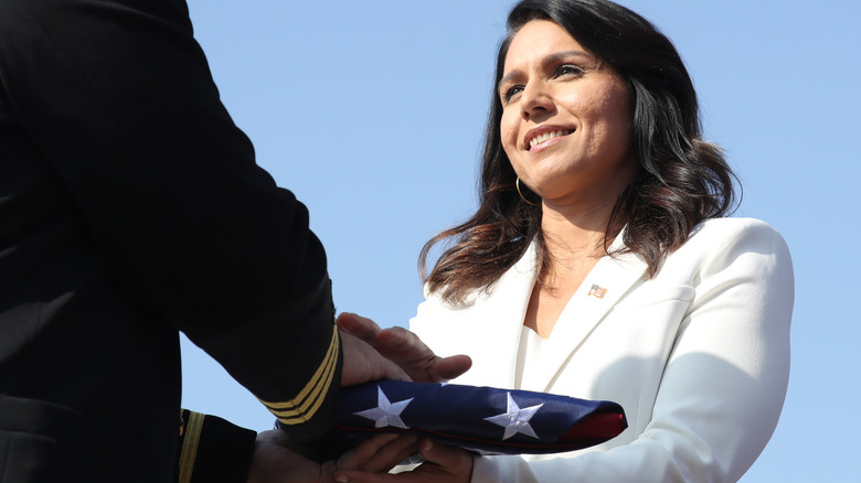 Tulsi Gabbard receiving a veteran flag