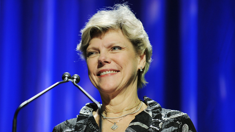 Cokie Roberts smiling in front of microphone 