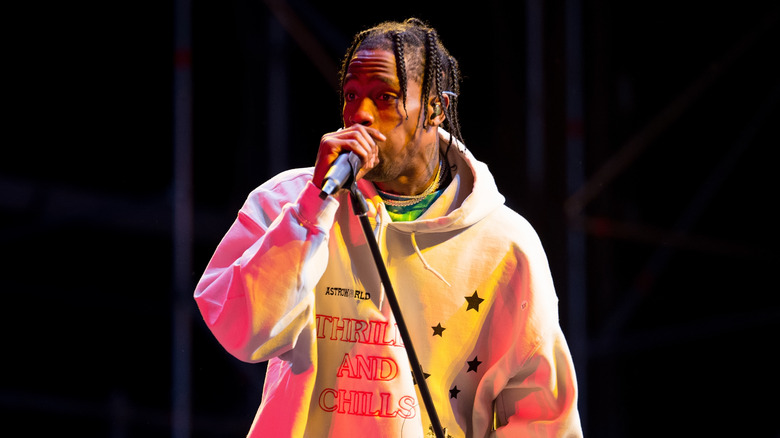 Travis Scott performs in a hoody