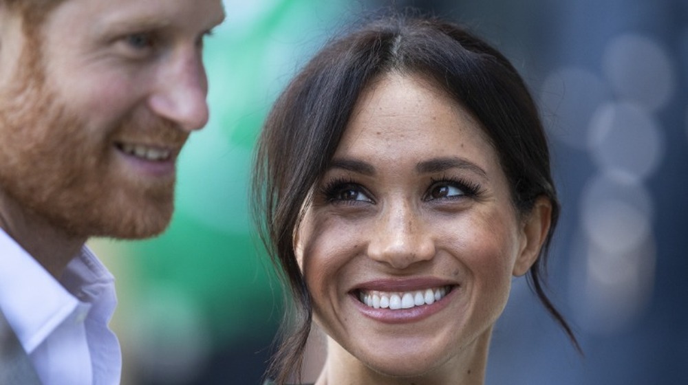 Meghan Markle looking at Prince Harry lovingly at an event