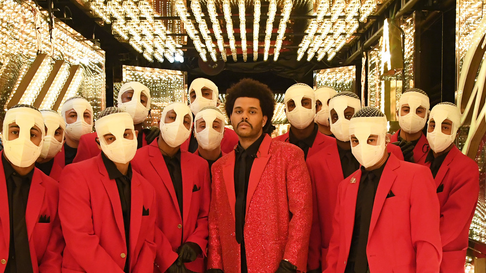 The Weeknd posing with halftime performers