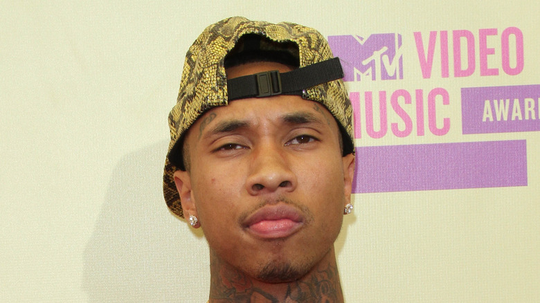 Tyga with snakeskin cap on