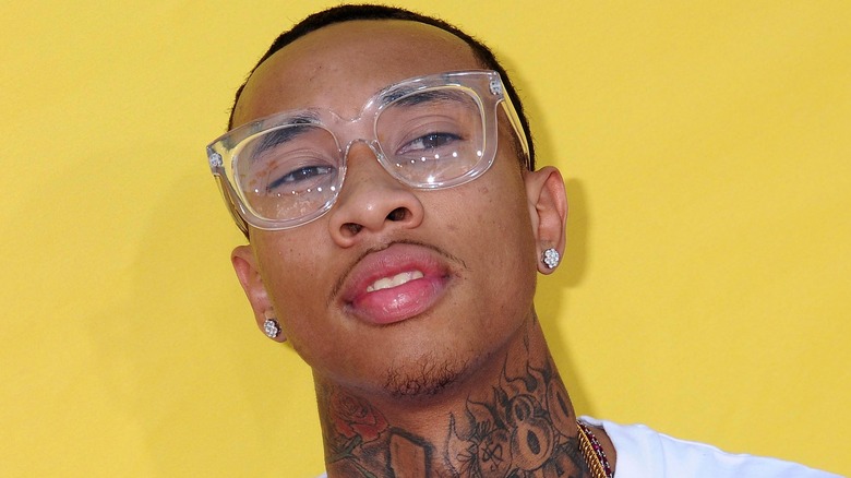 Tyga with clear shades on looking up with head tilted