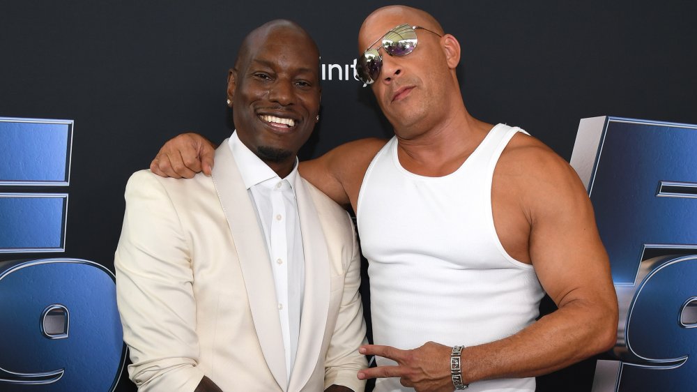 Tyrese Gibson and Vin Diesel, both in white and posing together at a Fast & Furious movie premiere