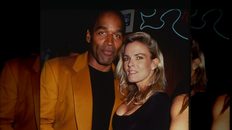 O.J. Simpson smiling, Nicole Simpson black dress