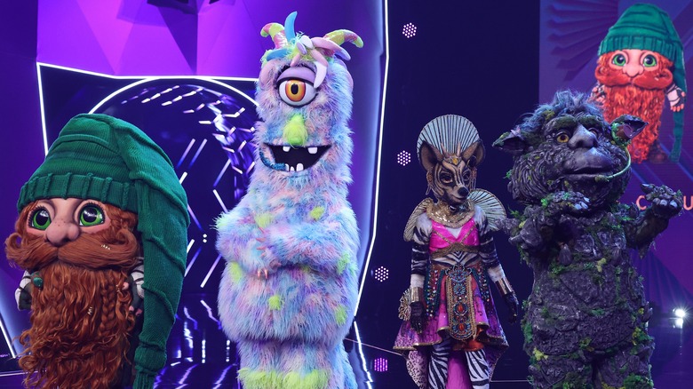 Masked Singer contestants standing in costumes