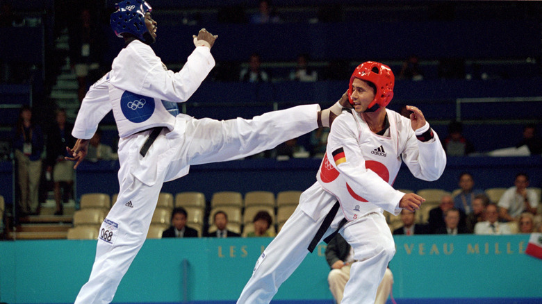 Ángel Matos kicking an opponent in 2000