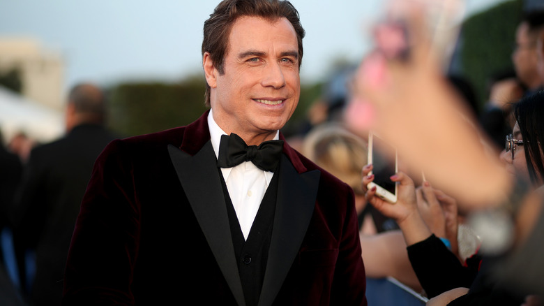 John Travolta smiling on red carpet