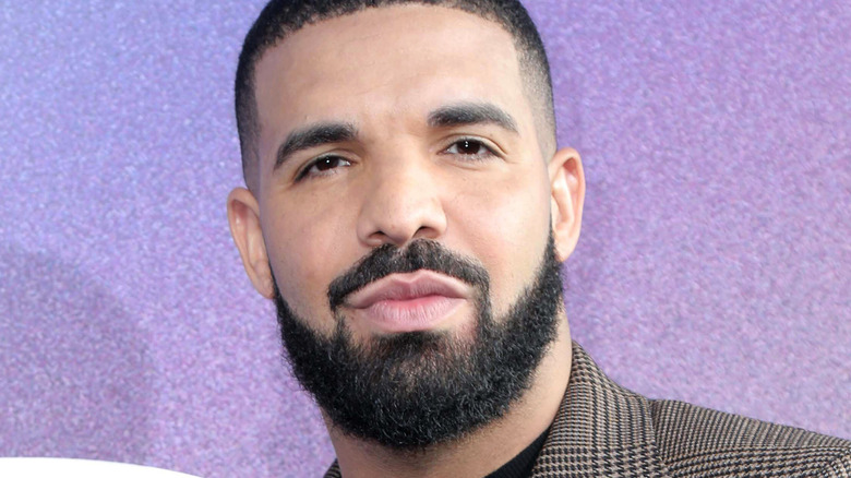 Drake wearing a blazer, posing