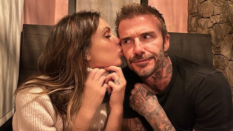 Victoria Beckham kissing David Beckham's cheek