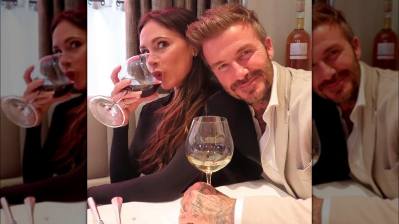 Victoria and David Beckham drinking wine