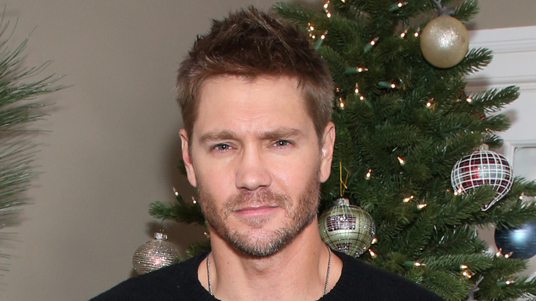 Chad Michael Murray in front of Christmas tree