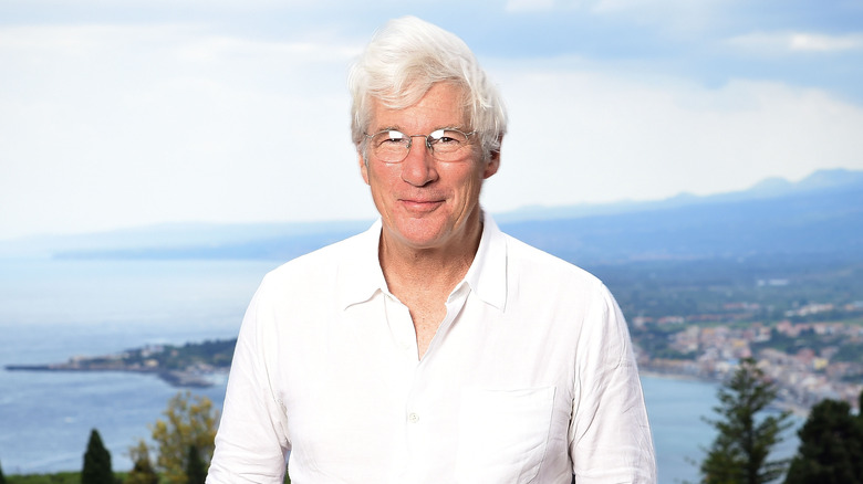 Richard Gere smiling wearing glasses