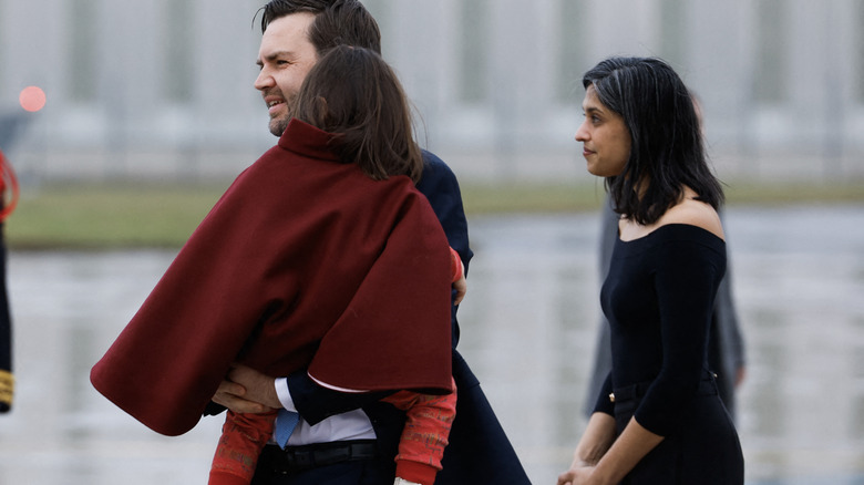 Usha Vance walking behind JD Vance carrying daughter Mirabel