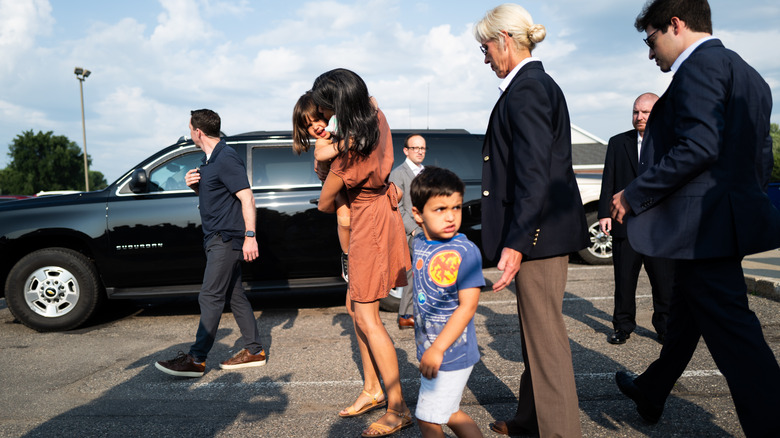 Usha Vance carrying daughter and walking with son