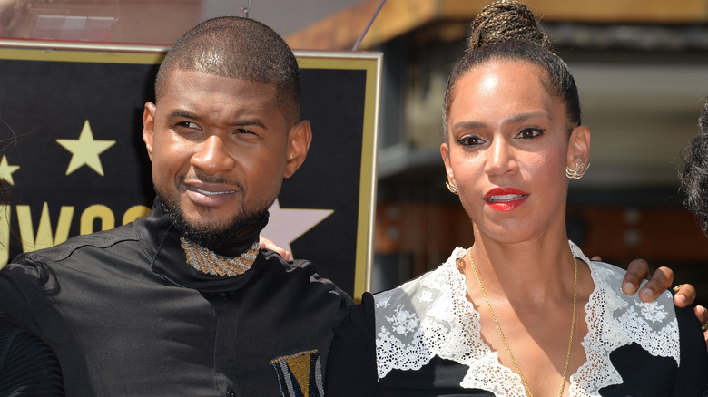 Usher posing with Grace Miguel