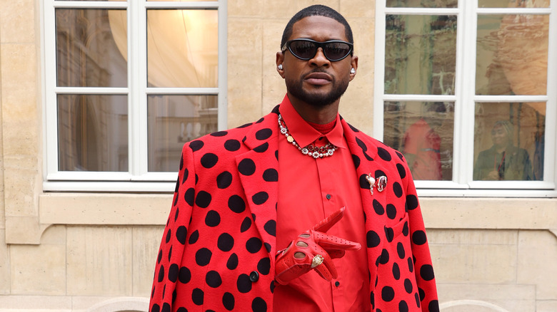 Usher in a red polka dot outfit