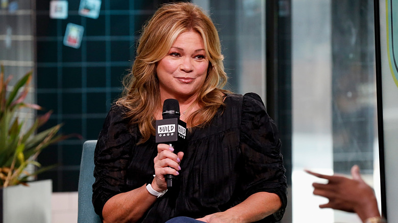 Valerie Bertinelli holding a microphone