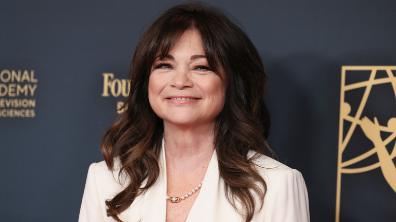 Valerie Bertinelli smiles while wearing white