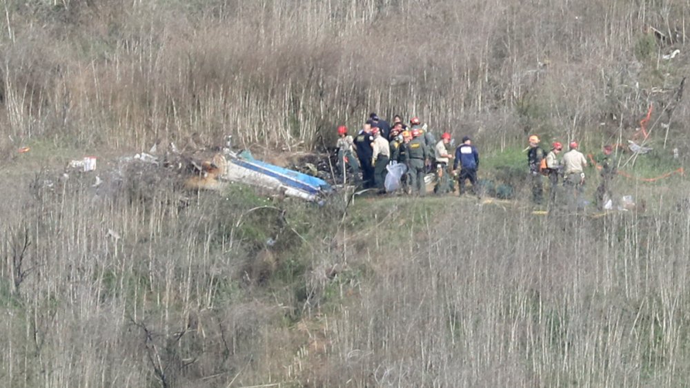 Officials investigate the helicopter crash site.