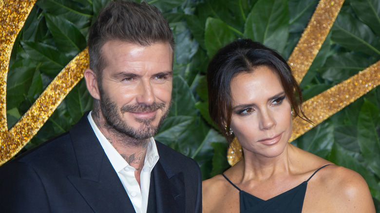 Victoria and David Beckham pose 