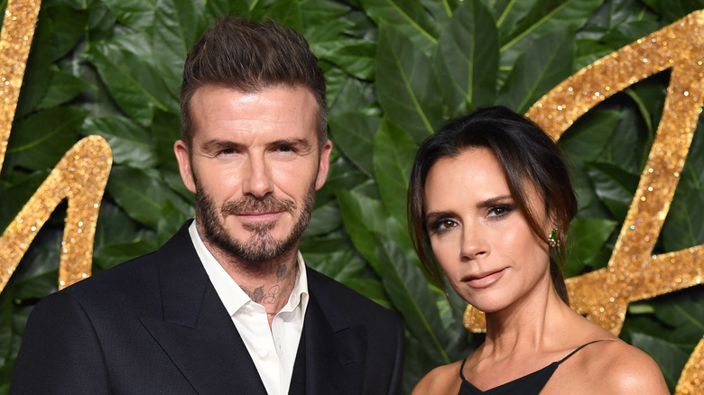 David Beckham and Victoria Beckham posing