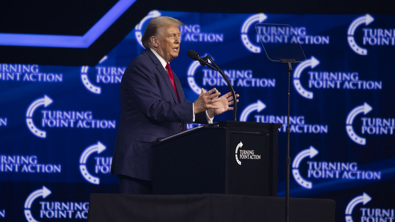 Donald Trump speaking at podium 