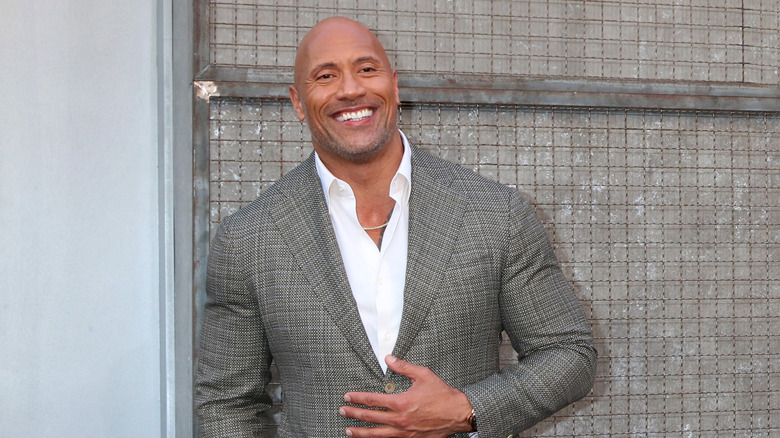 Dwayne Johnson smiling and wearing suit