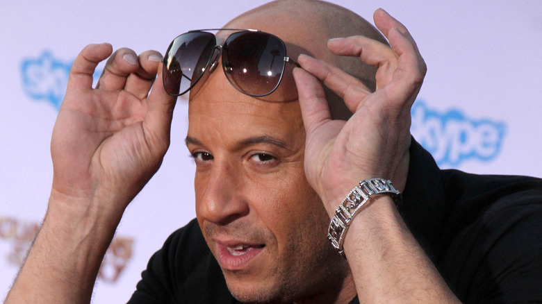 Vin Diesel holding sunglasses