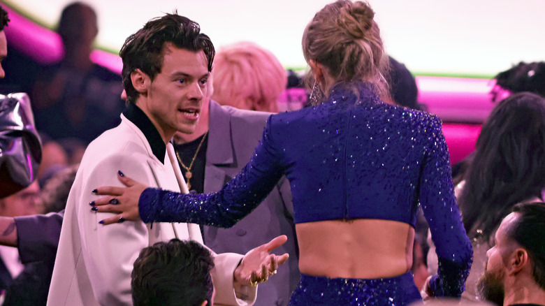 Taylor Swift touching Harry Styles' arm