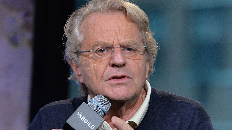 Jerry Springer talks into a microphone