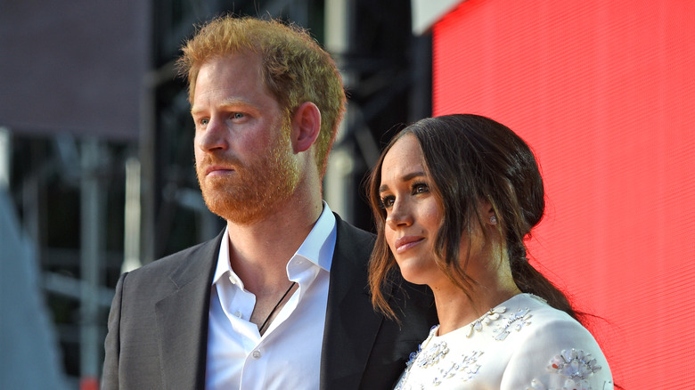 Prince Harry and Meghan Markle with serious expressions