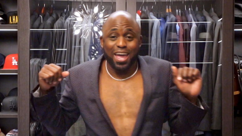 Wayne Brady in his closet, looking excited