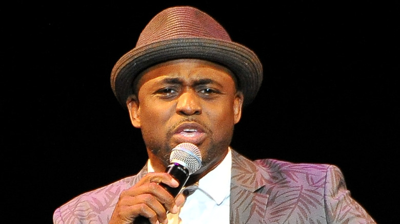 Wayne Brady holding microphone