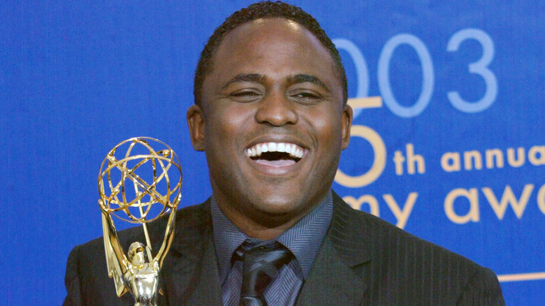 Wayne Brady laughing, holding Emmy