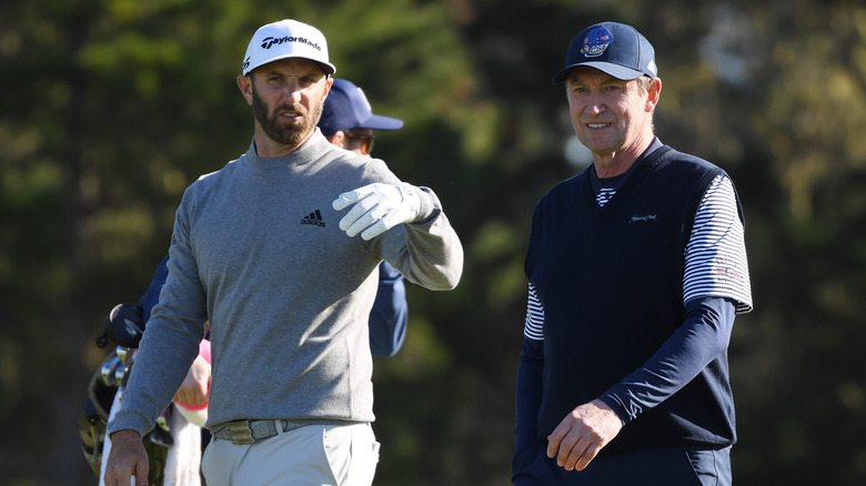 Dustin Johnson and Wayne Gretzky playing golf in 2015