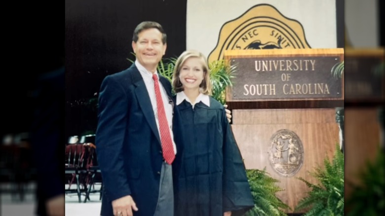 Ainsley Earhardt posing in collge gown with her dad