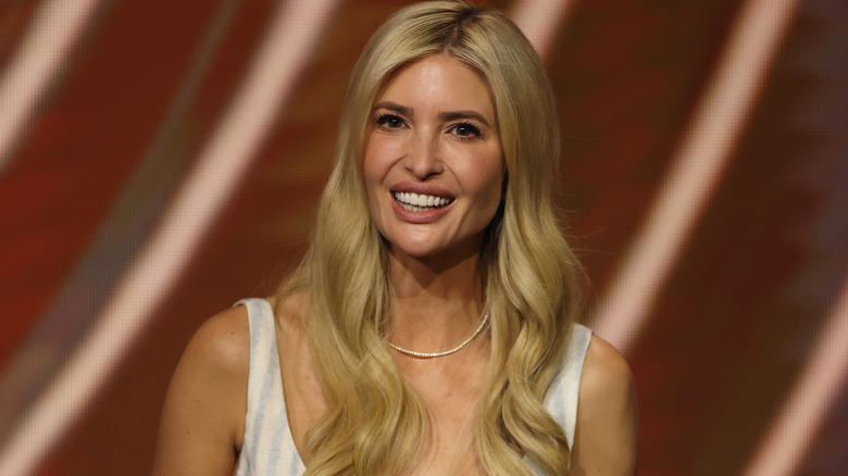 Ivanka Trump wearing a white dress and smiling