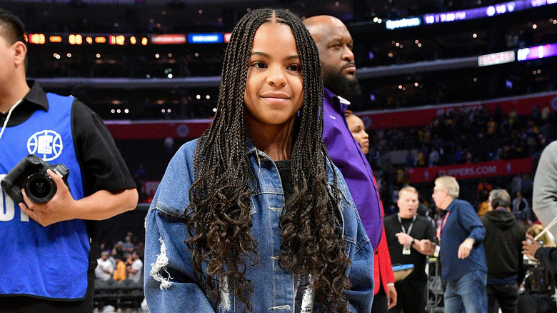 Blue Ivy at an NBA game with braided hair