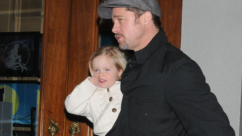 Brad Pitt holding Shiloh Jolie-Pitt 