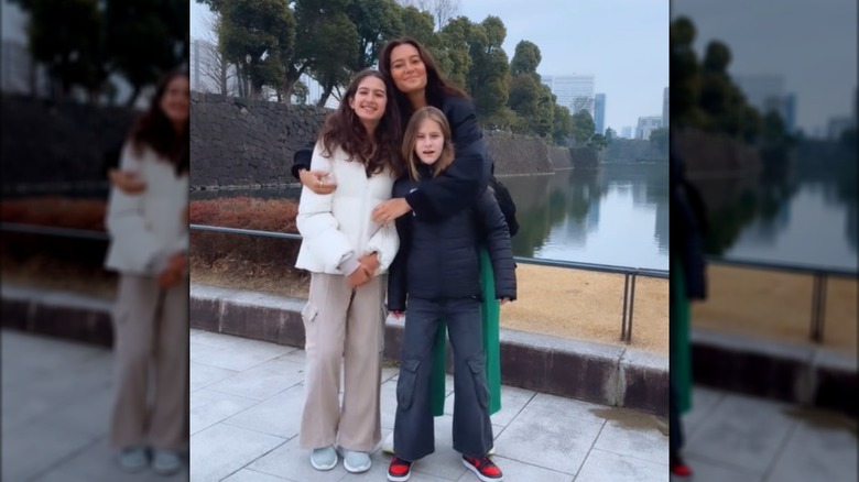 Emma Heming Willis hugging her daughters outdoors